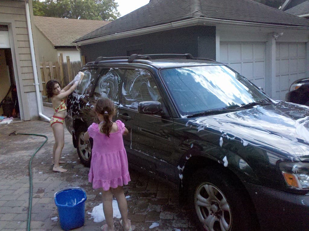 The girls wash the car
